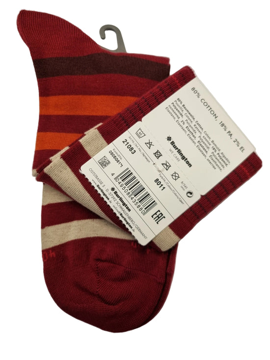 A pair of striped knit socks with red, beige, orange, and dark brown vertical bands, shown with their paper tags attached on a white background.