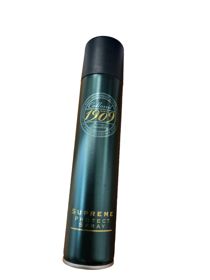 A can of Classic 1969 Supreme Protect Spray in a dark metallic green color with gold lettering, placed on a wooden desk with papers and a receipt in the background.